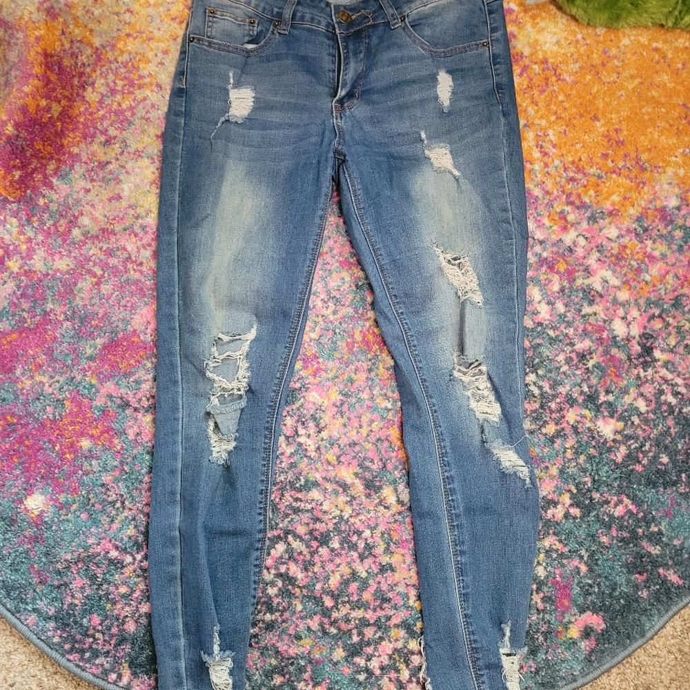 light blue skinny holy/ripped jeans